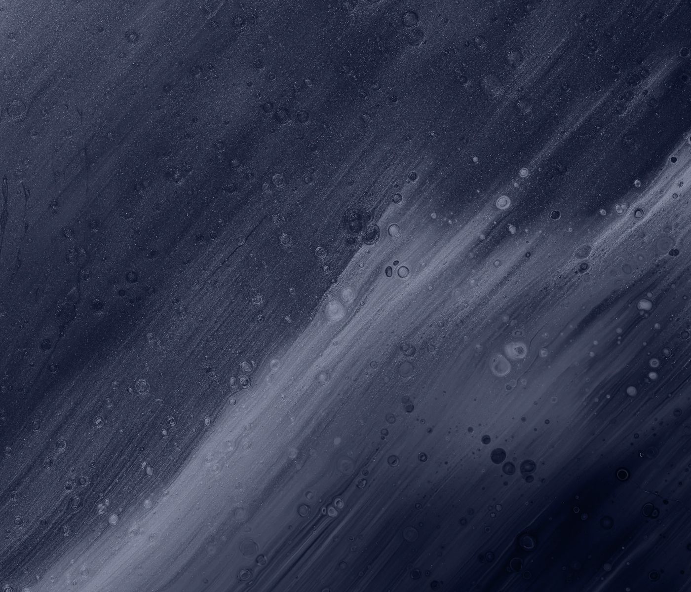 Abstract dark blue textured background with bubbles.