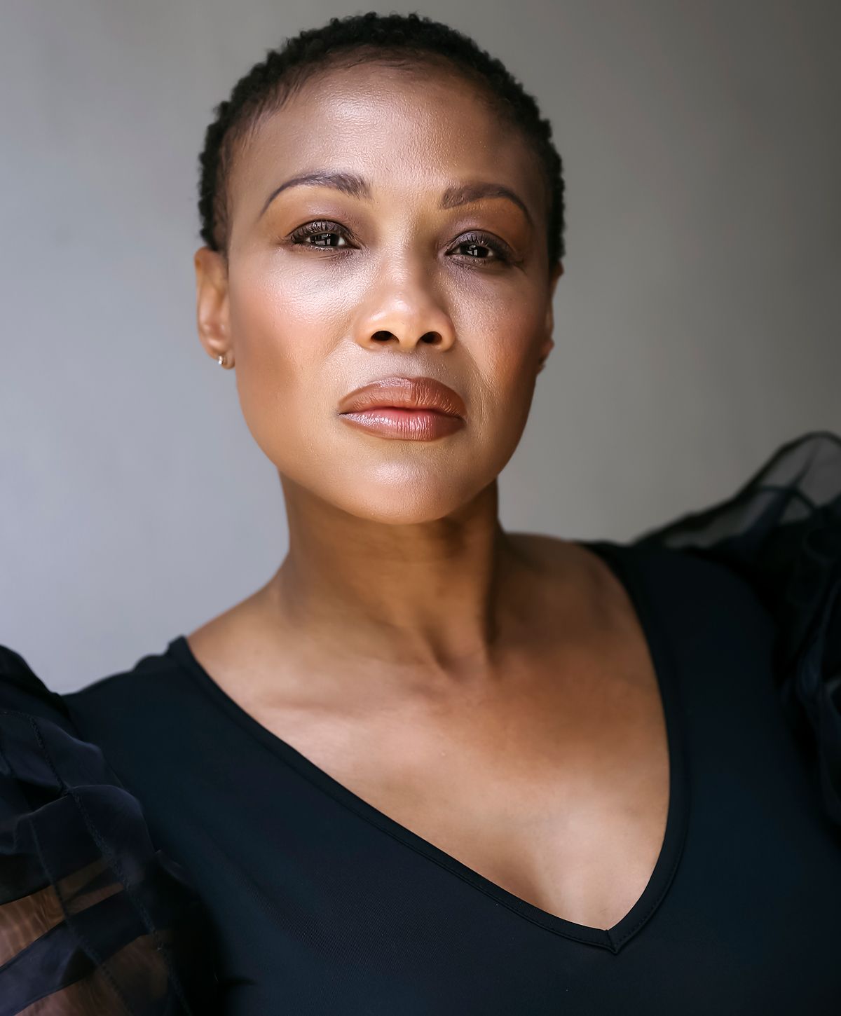 Portrait of a woman with short hair, serious expression.