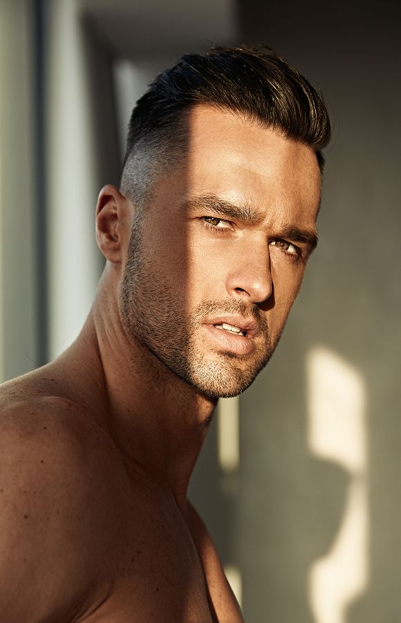 Man with stylish haircut and intense expression.