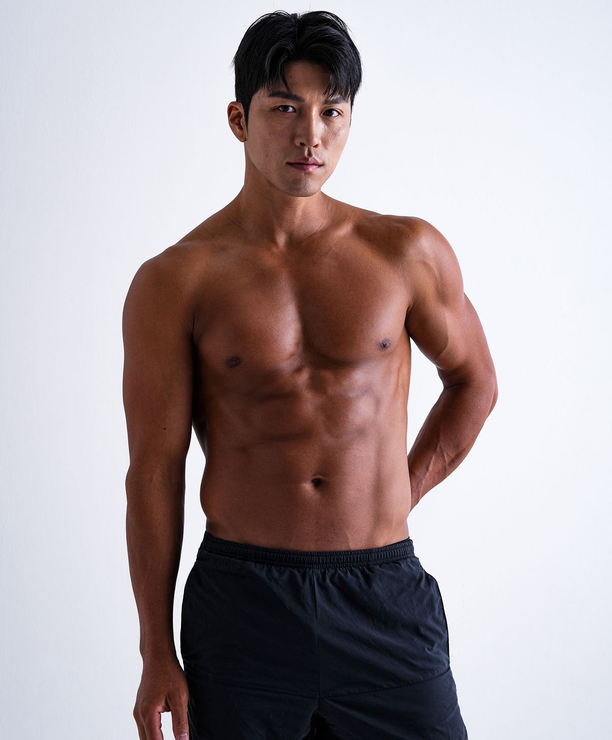 Athletic young man posing against a white background.