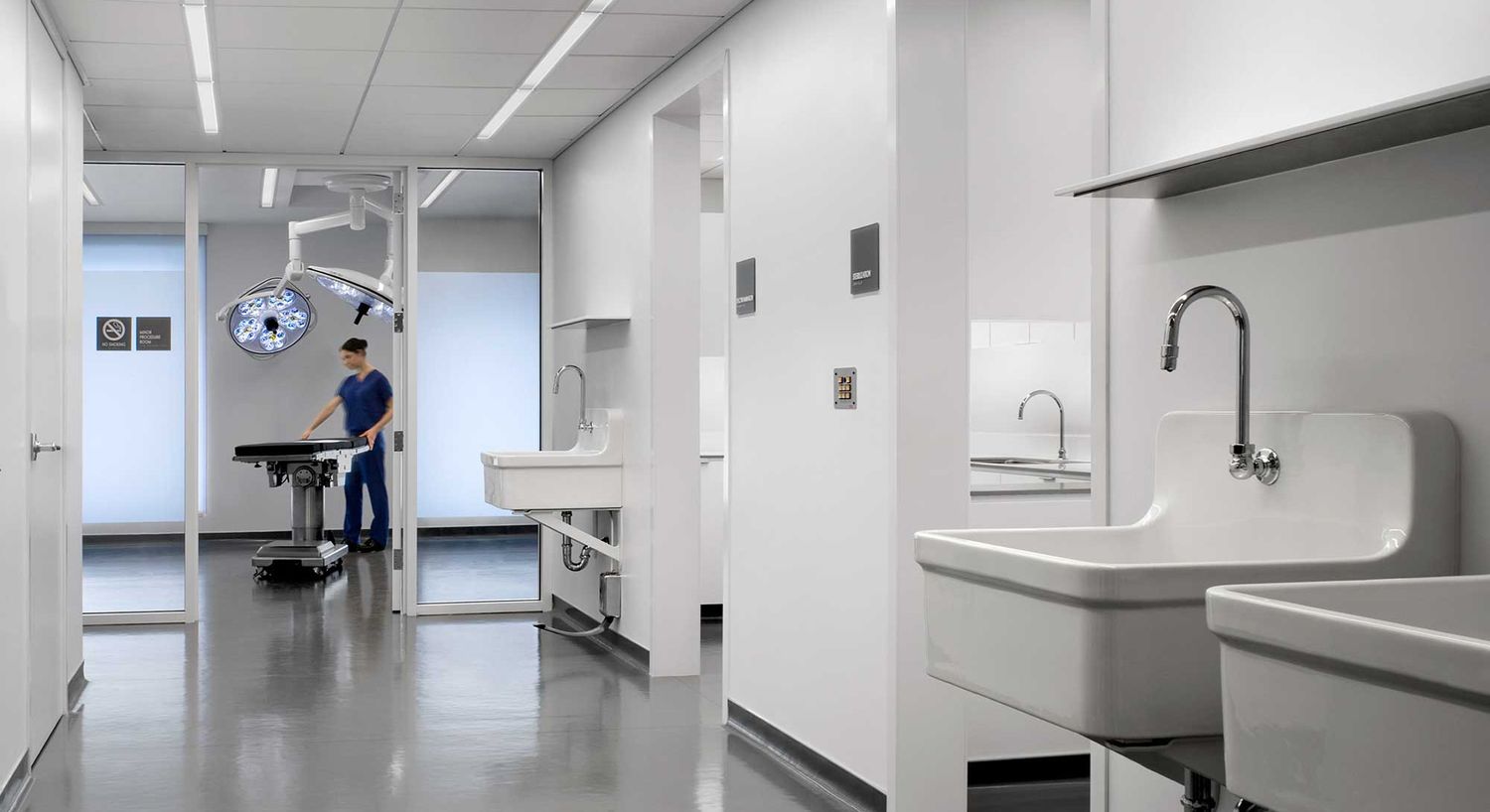 Modern surgical room with medical equipment and staff.