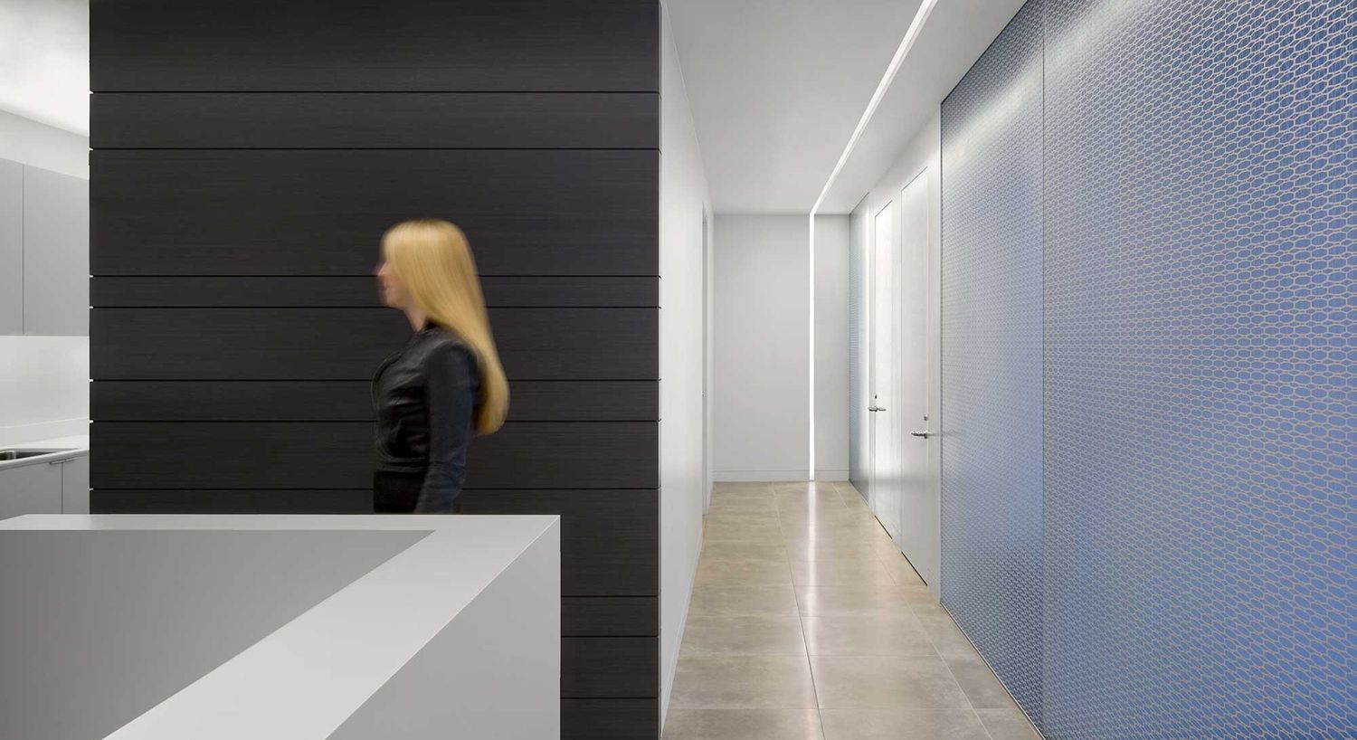 Modern interior with a person walking.