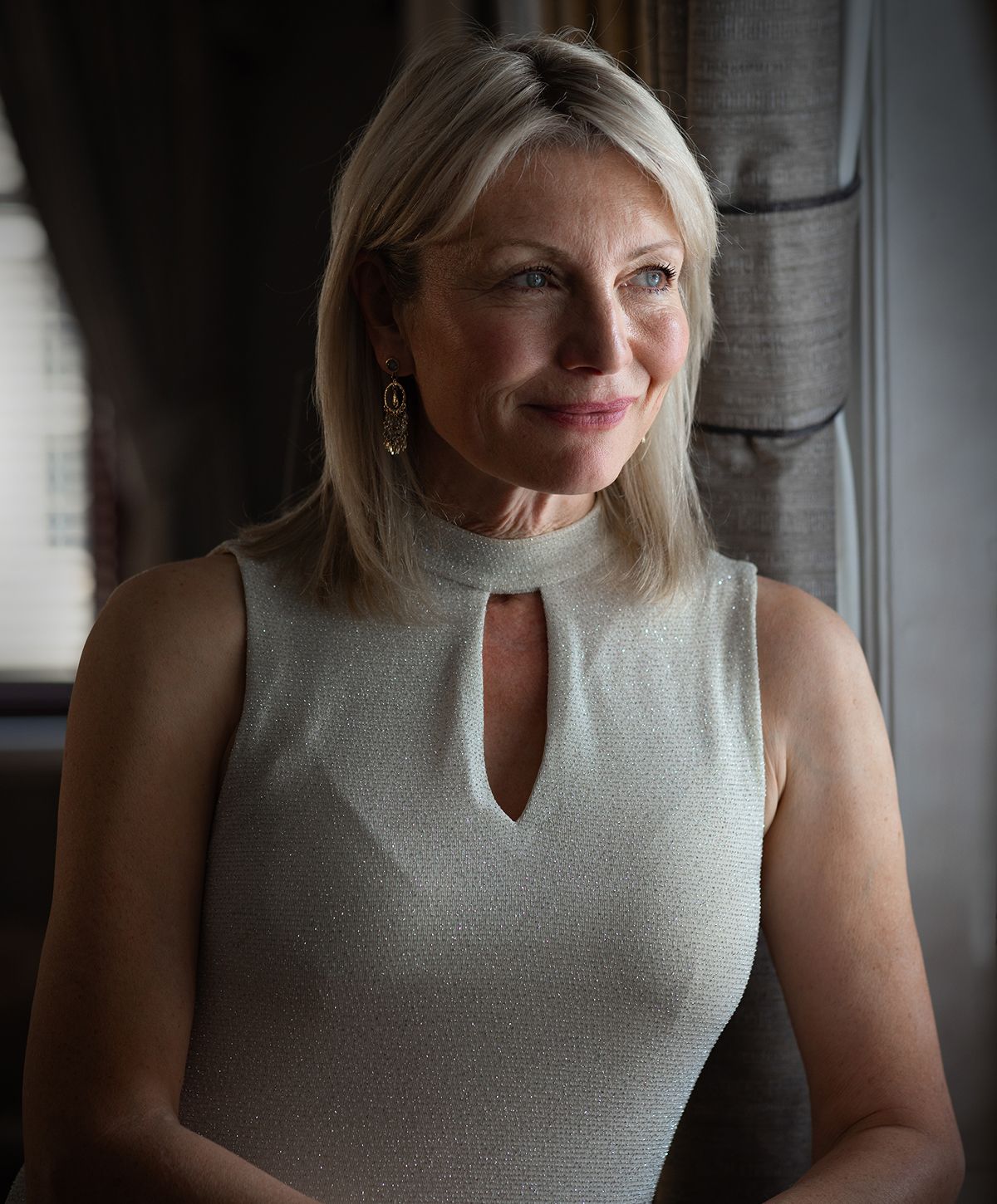 Woman in elegant dress with natural light background.