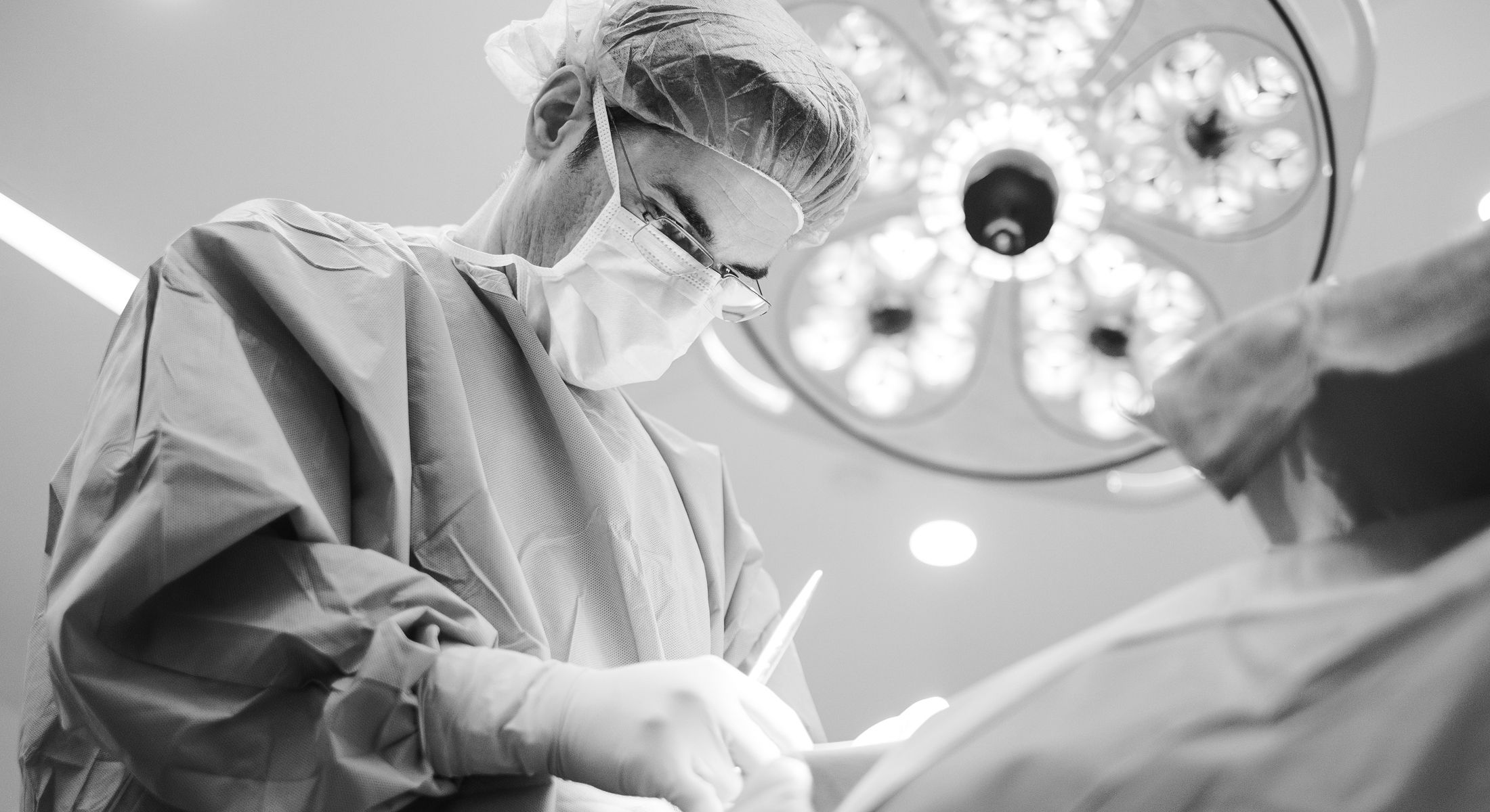 Surgeon performing a procedure in operating room.