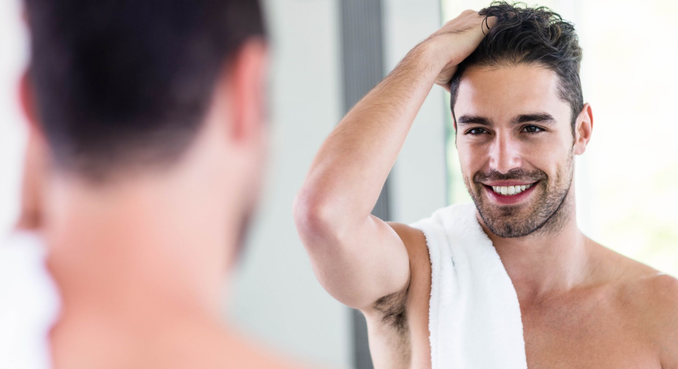 Woman with long hair wearing a sun hat.
