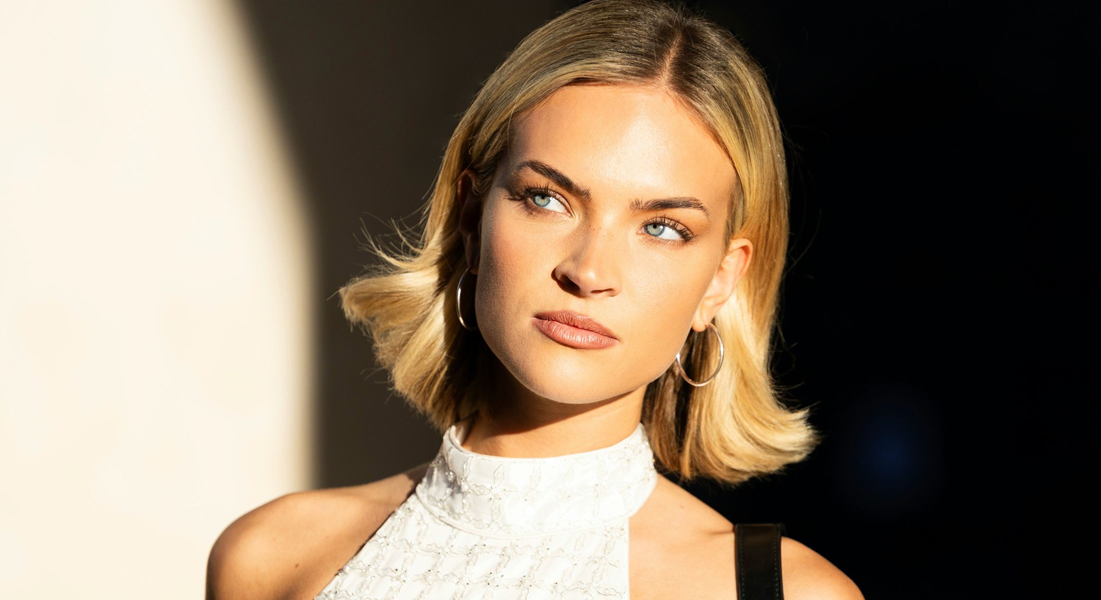 Woman with long hair wearing a sun hat.