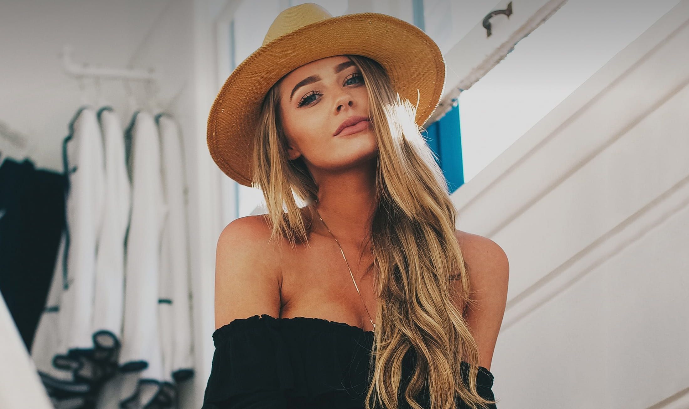 Woman with long hair wearing a straw hat.