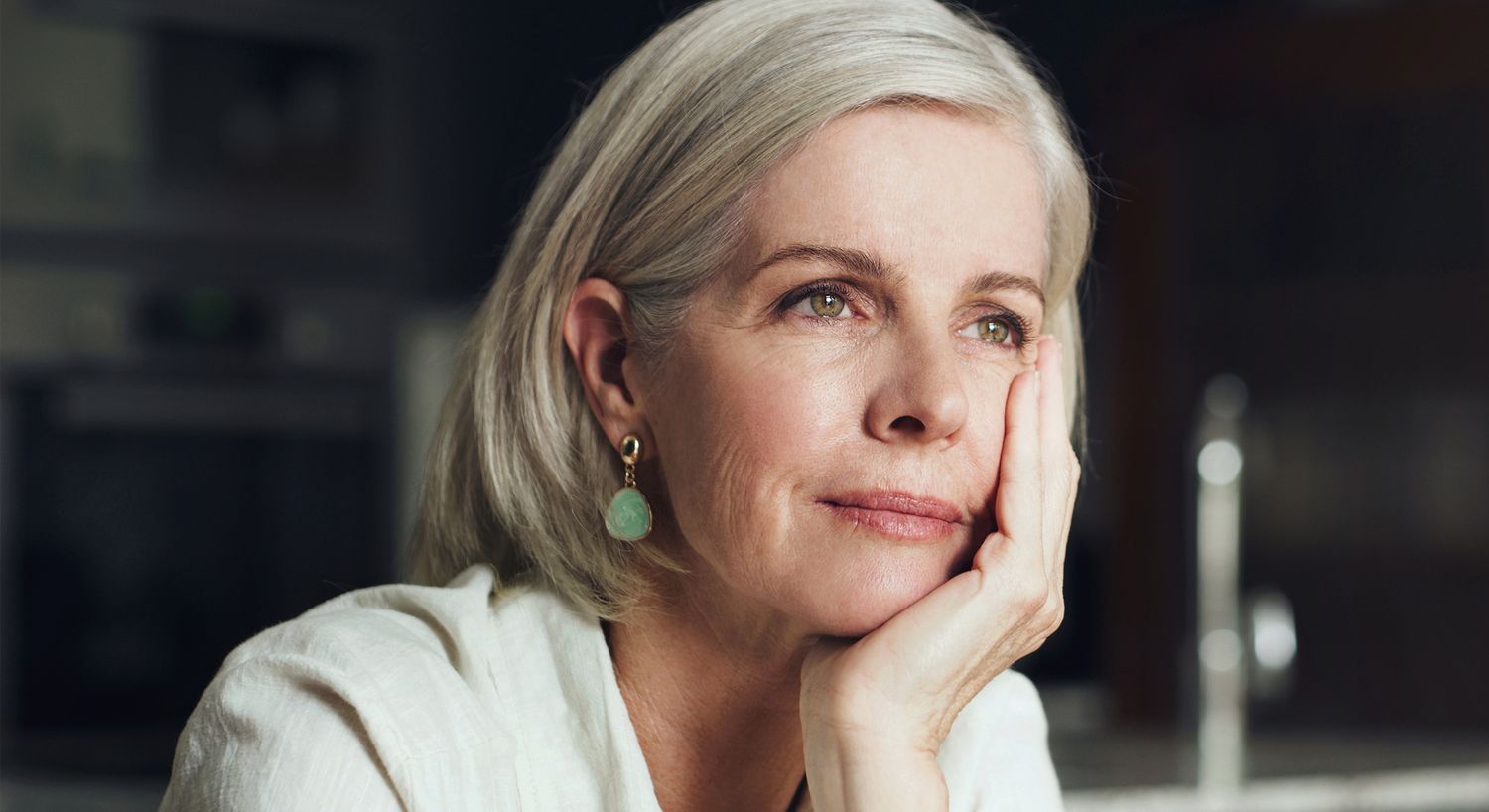 Thoughtful woman resting her chin on hand.