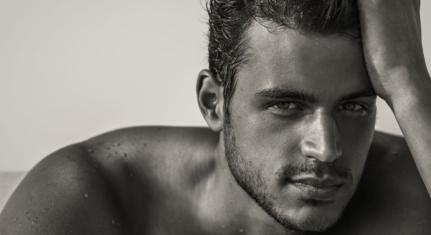 Black and white portrait of a muscular man.