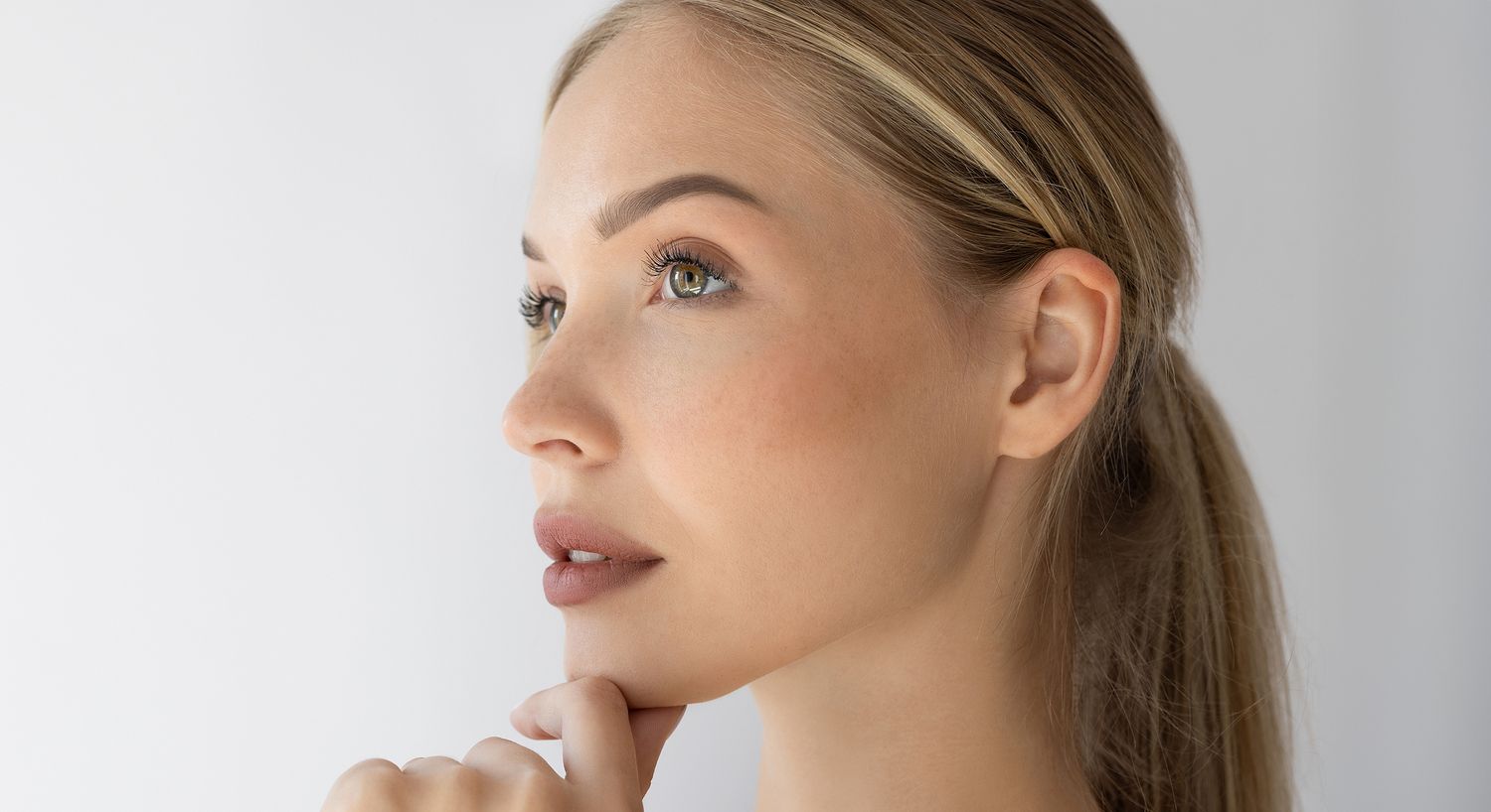 Profile of a thoughtful woman with long hair.